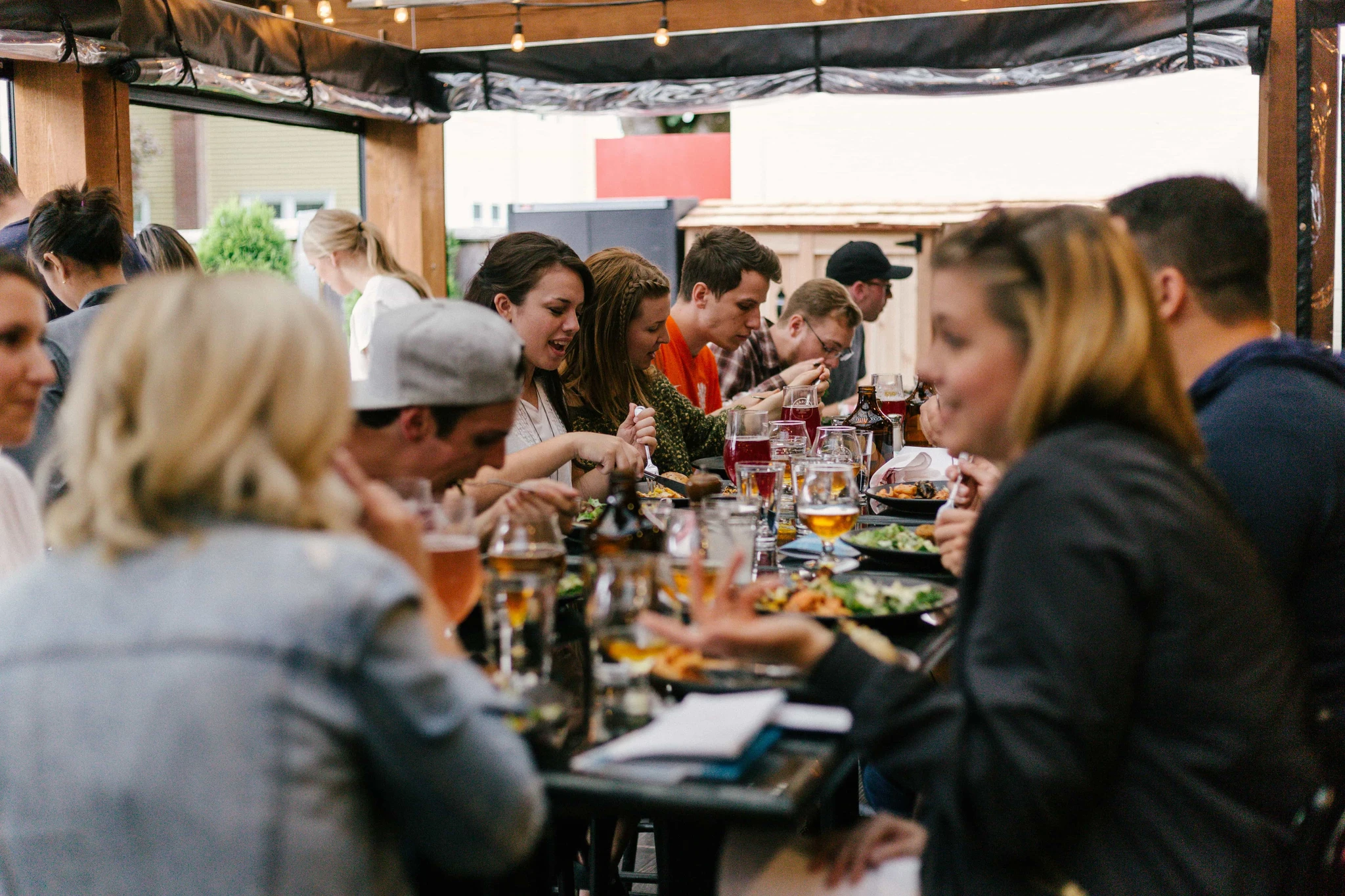 Guests sitting at a long table eating together