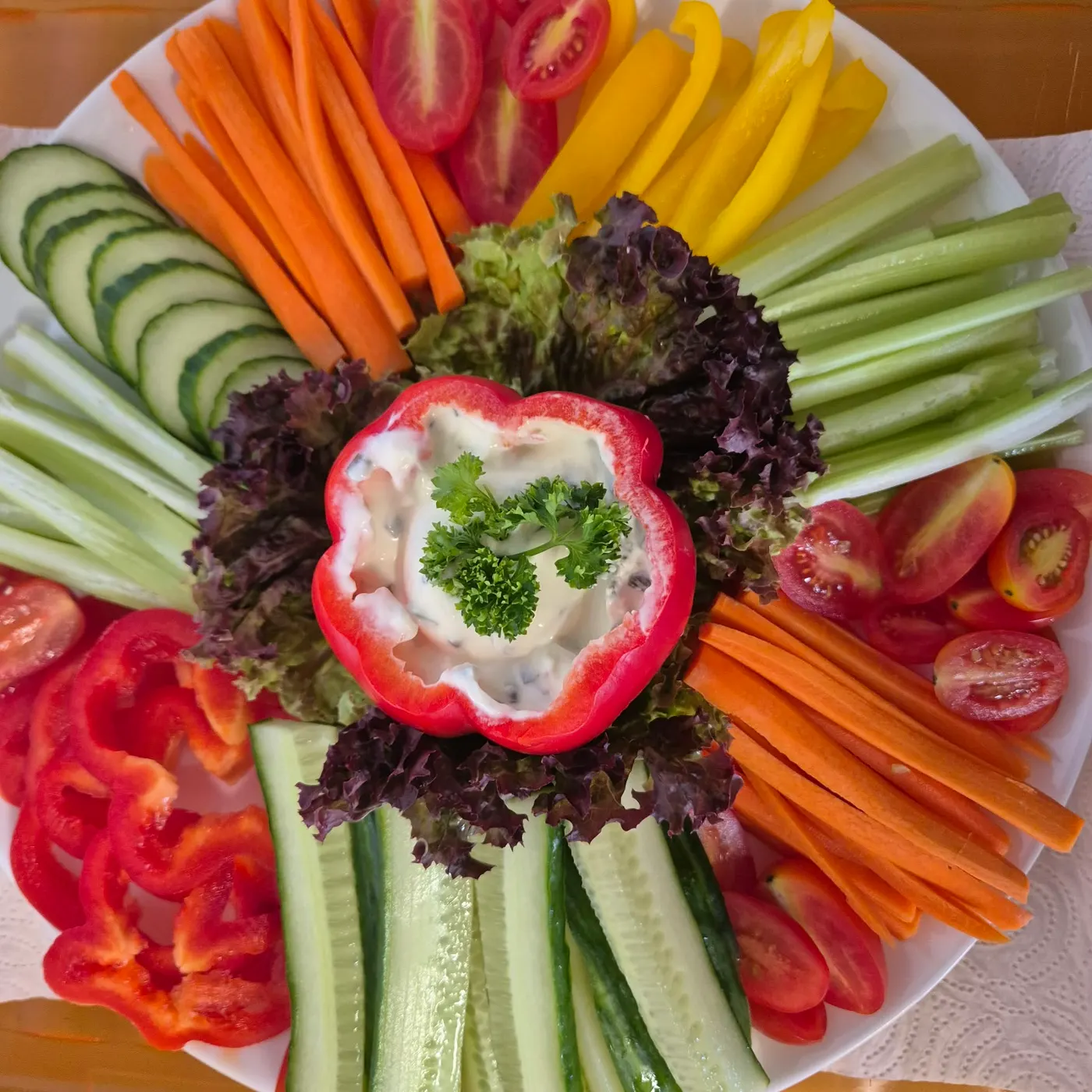Vegetable platter with carrots, cucumbers, peppers and herb dip