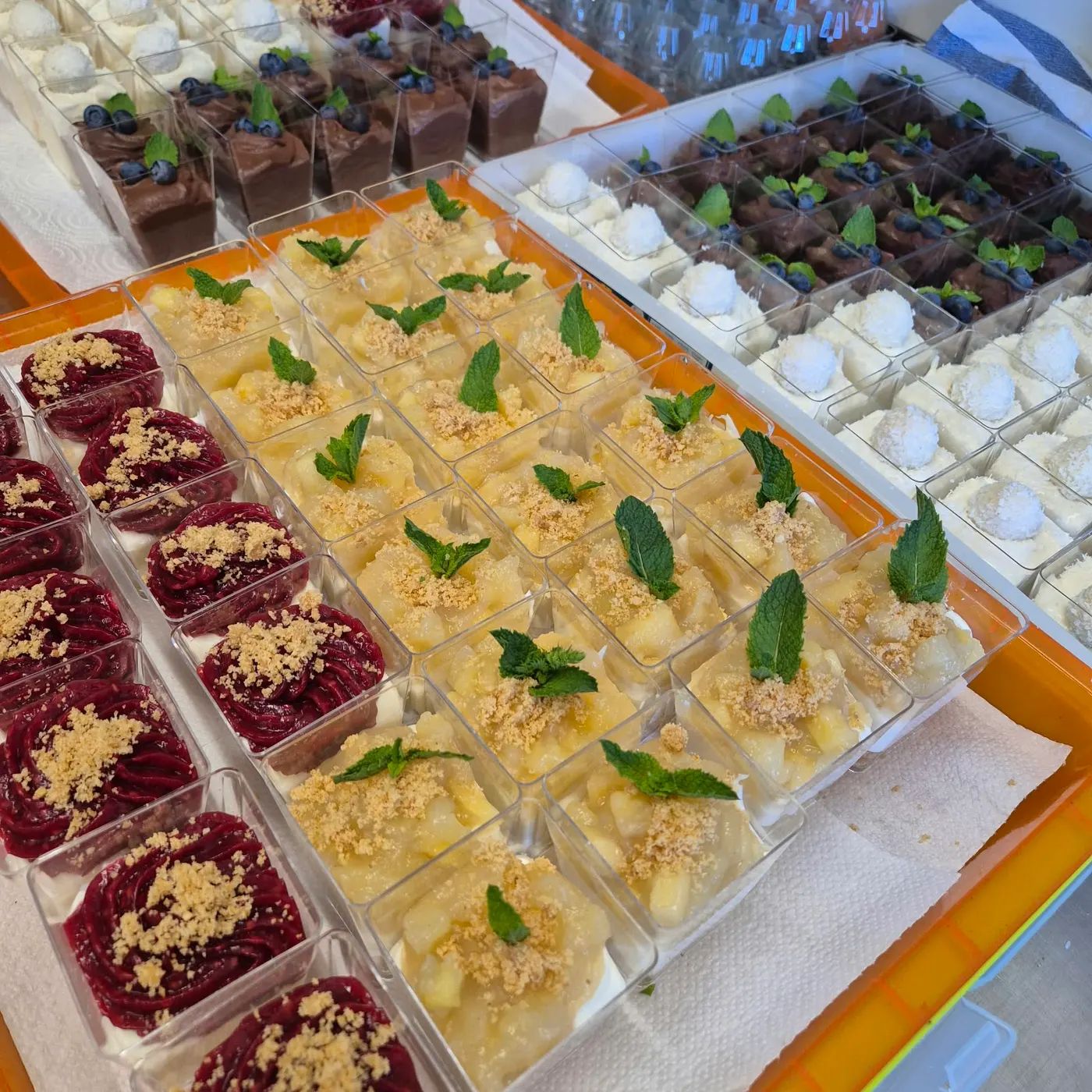 Desserts in cups with chocolate, red berry compote and apple crumble