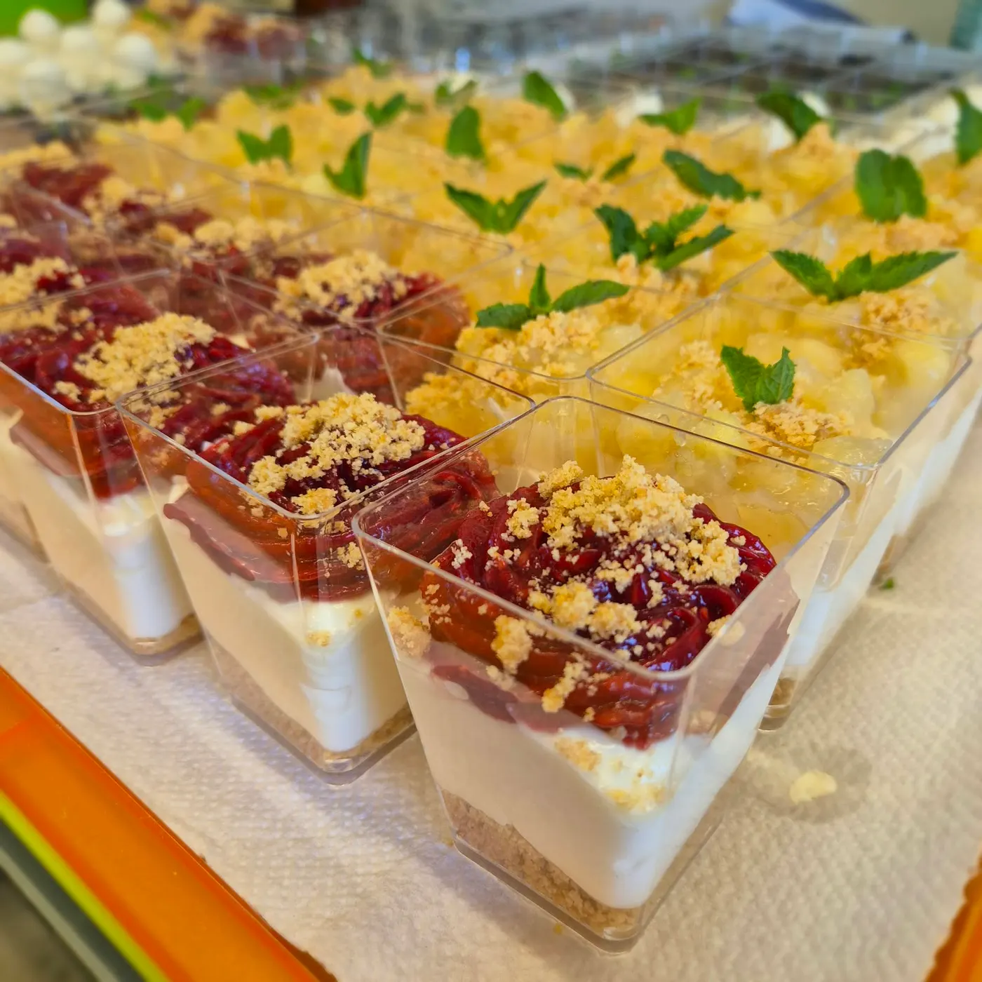 Layered desserts in cups with red berry compote and mint