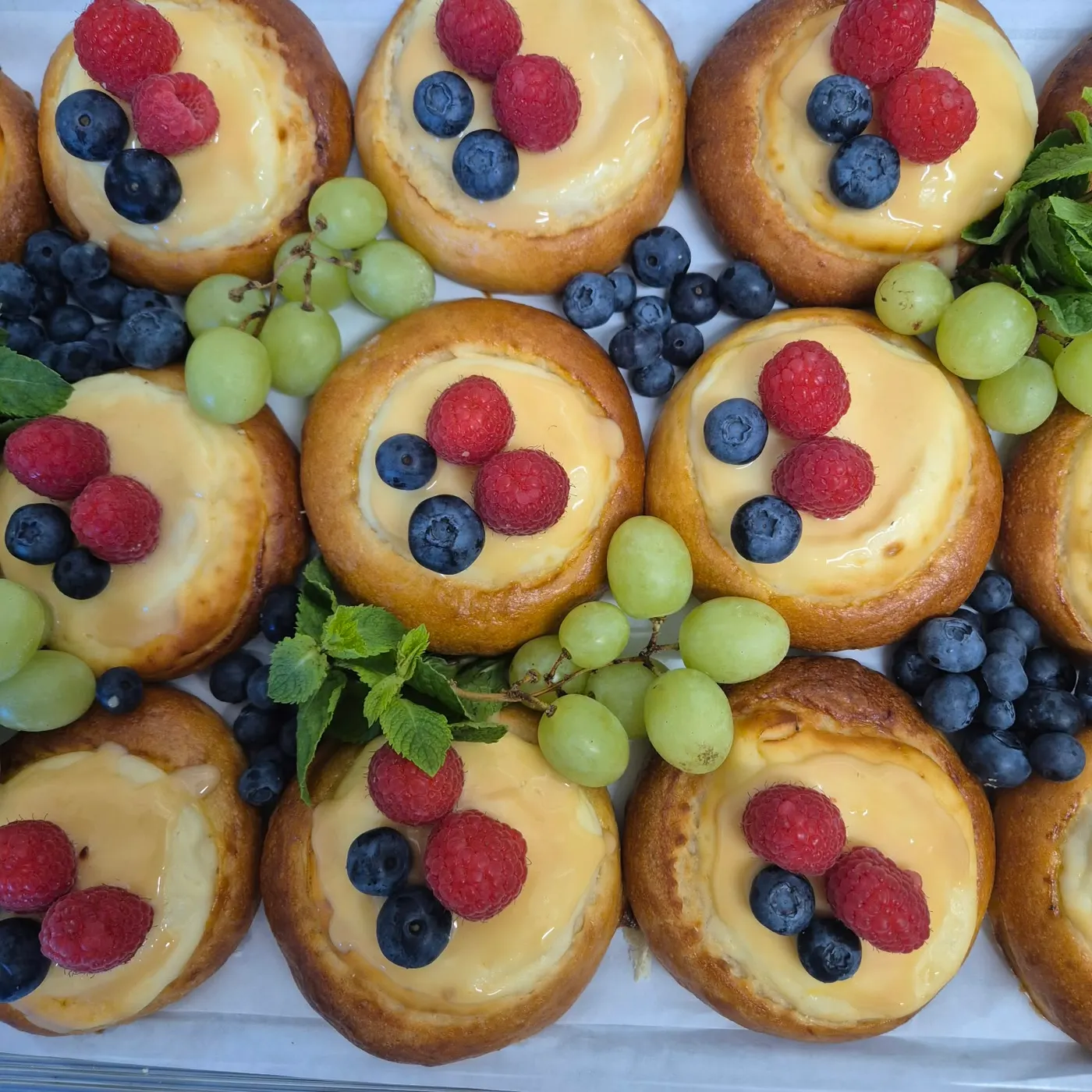 Yeast pastries with custard, raspberries and blueberries