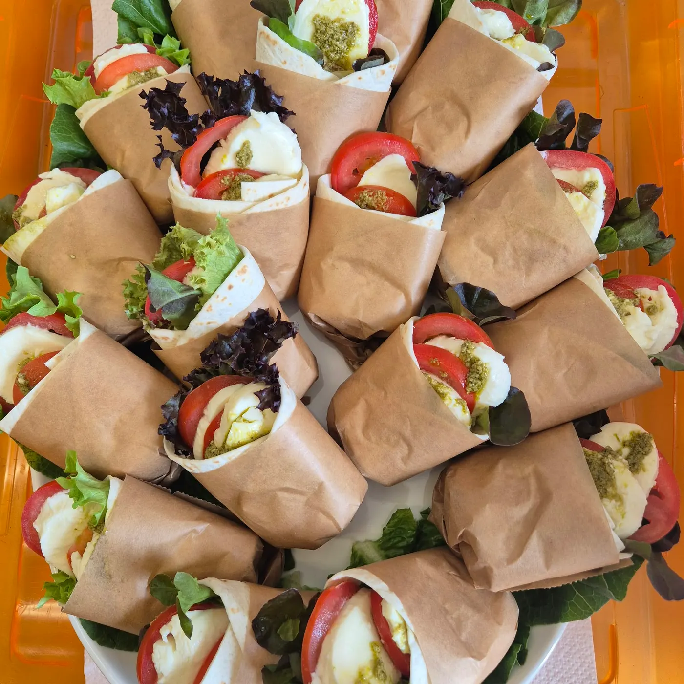 Tomato and mozzarella wraps in paper bags