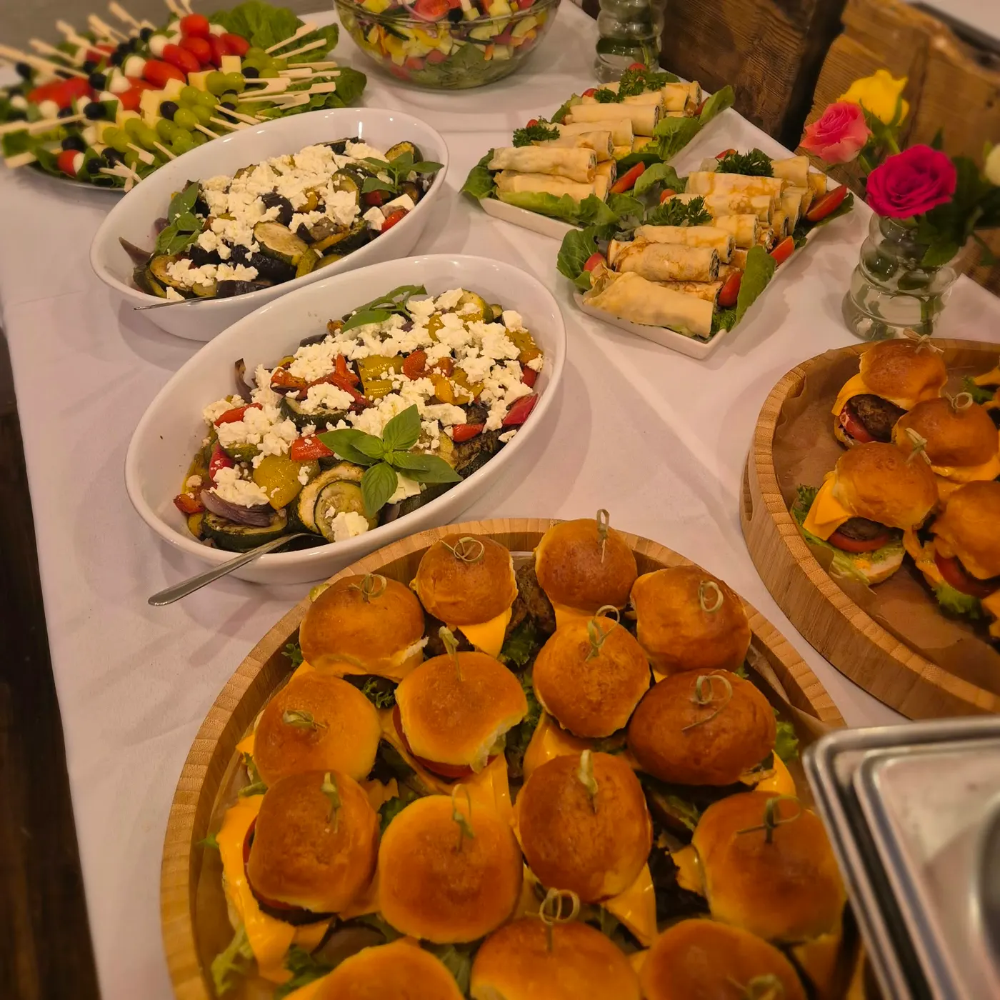 Buffet with mini burgers, salads and wraps