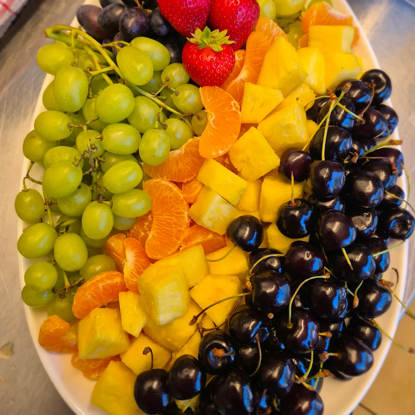Fruit platter with grapes, cherries, mandarins and pineapple