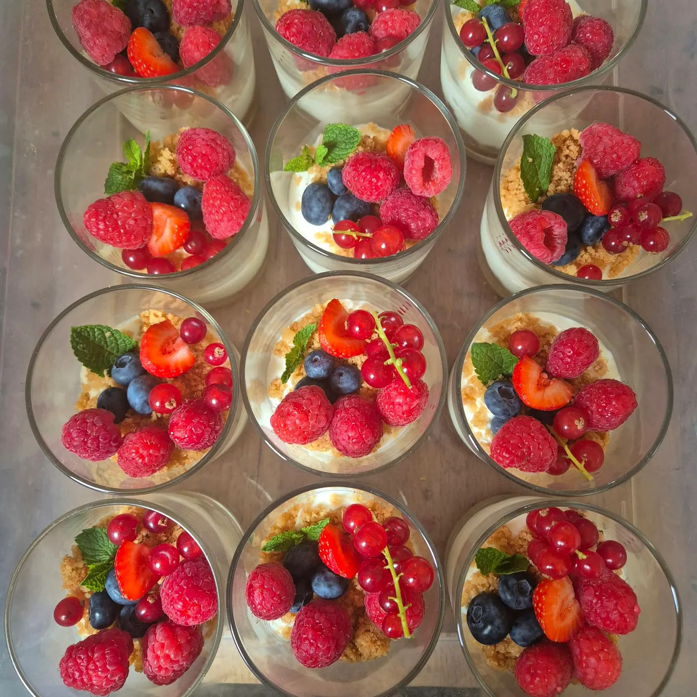 Dessert glasses with cream and fresh berries