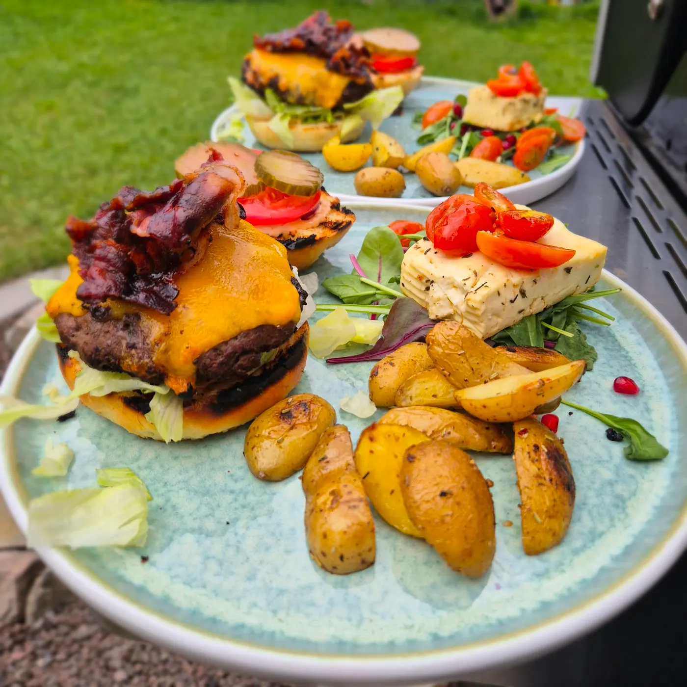 Burger with cheese, grilled cheese and potato wedges on a plate