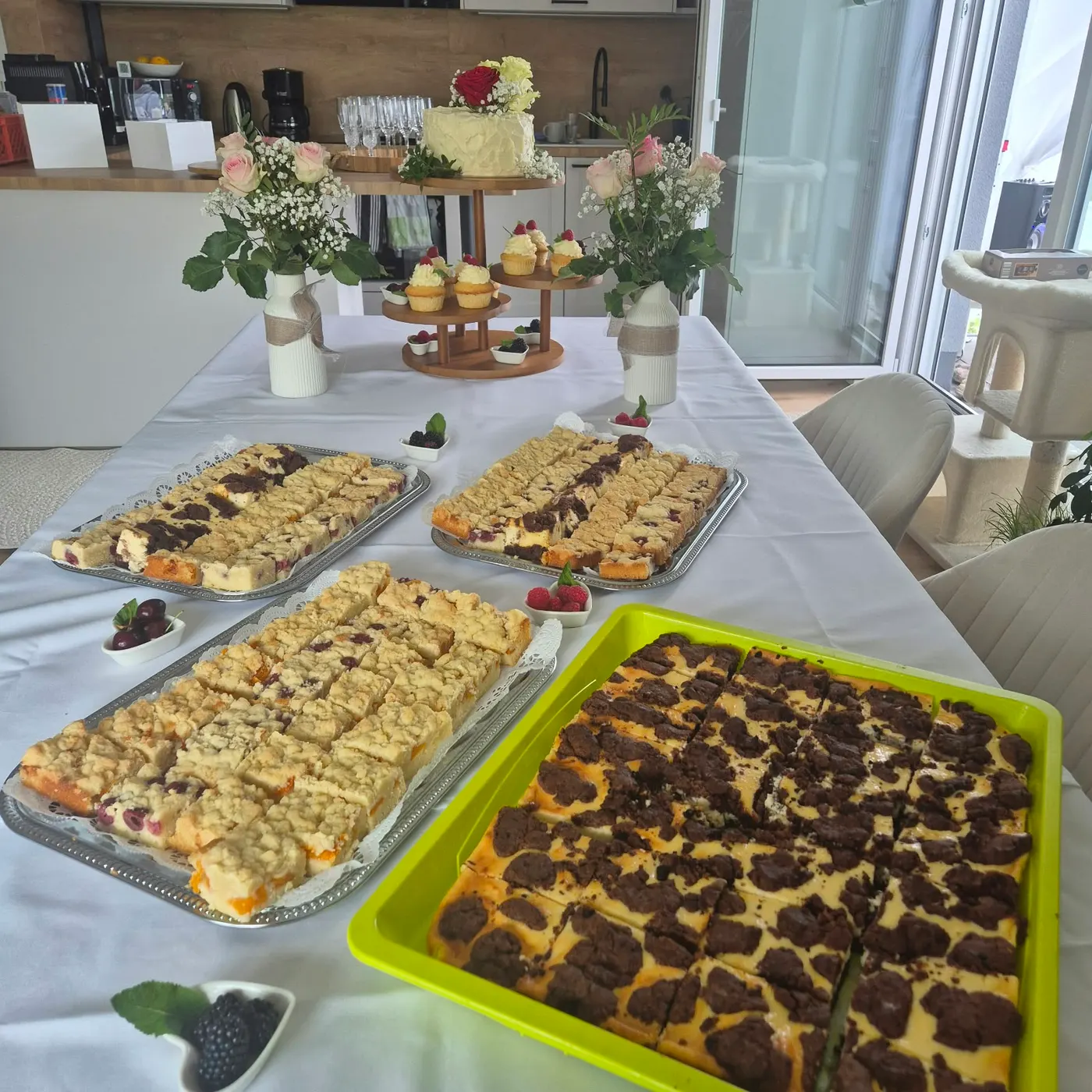 Cake table with sheet cakes and a gateau on a long table