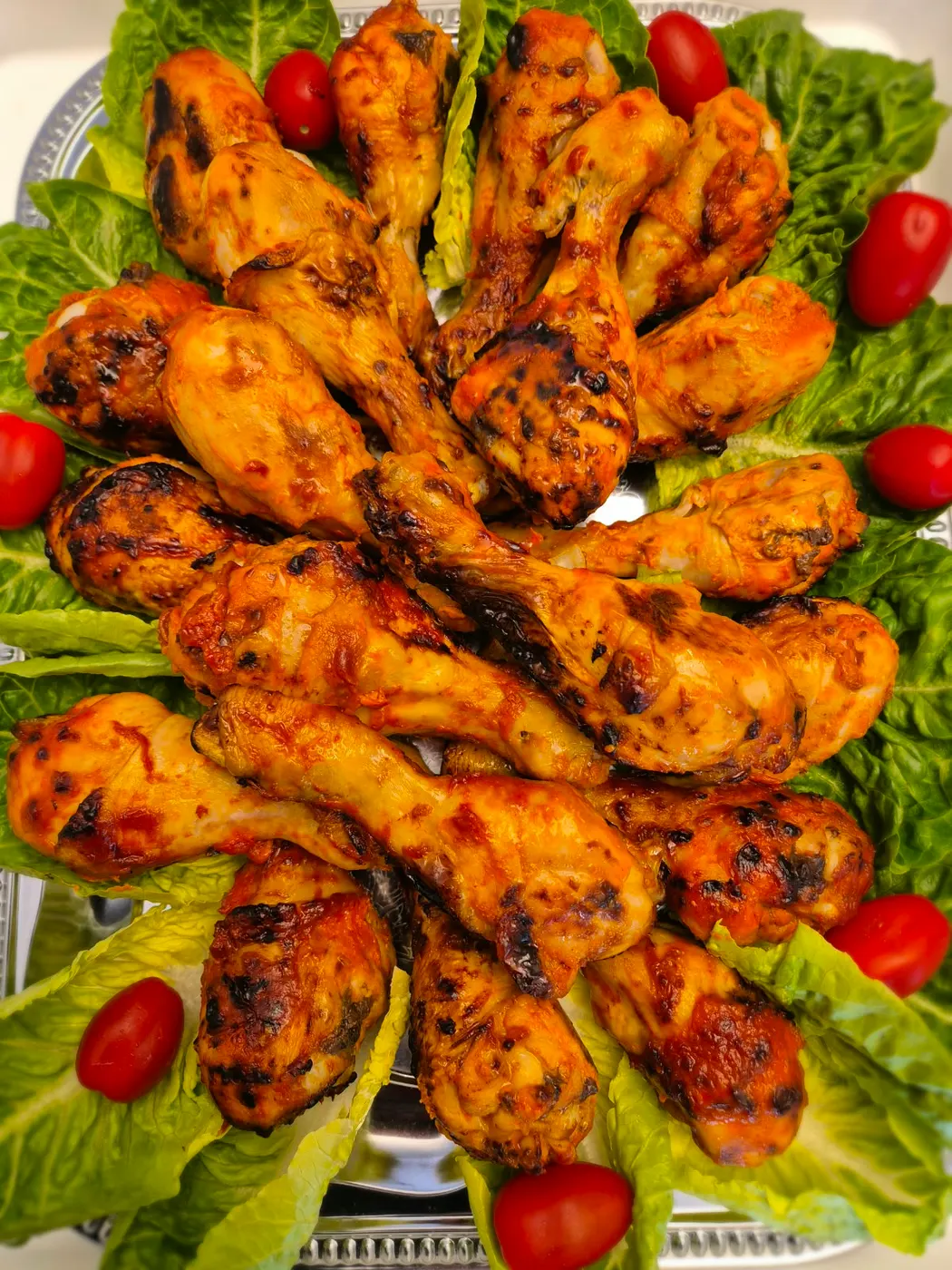 Grilled chicken legs on salad