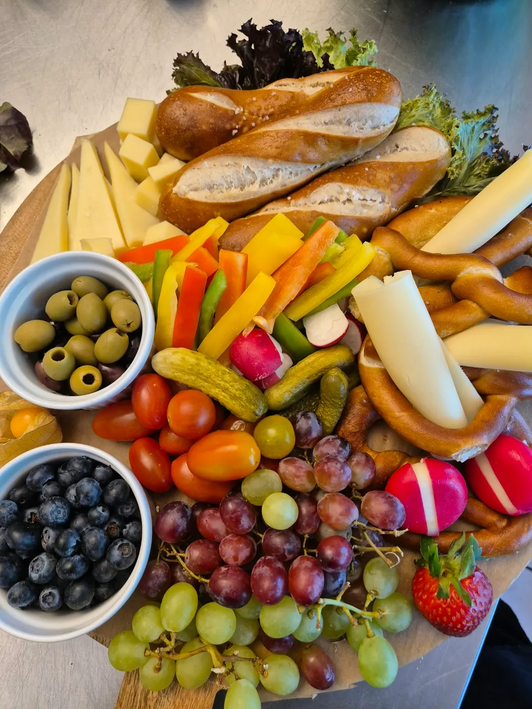Snack platter with pretzel sticks, cheese, vegetables and fruit