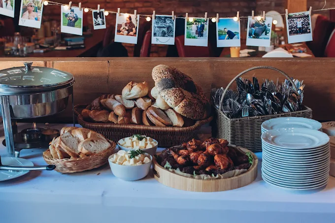 Breakfast buffet with rolls, bread and plates