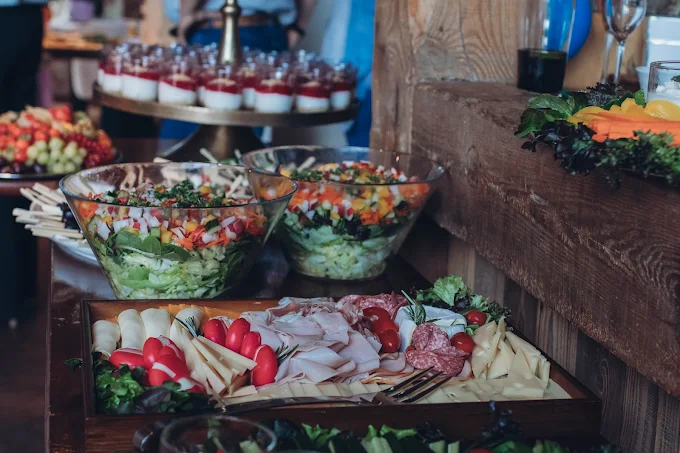 Salad buffet with bowls and cold cuts platters